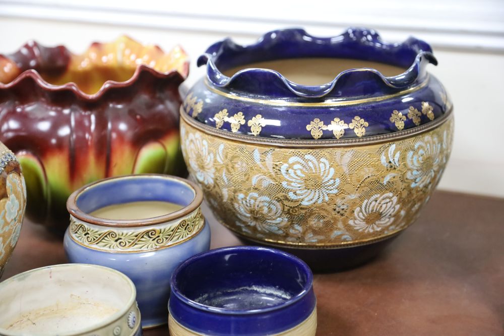 Two Doulton stoneware jardinieres, three similar small pots and a Bretby jardiniere (6)